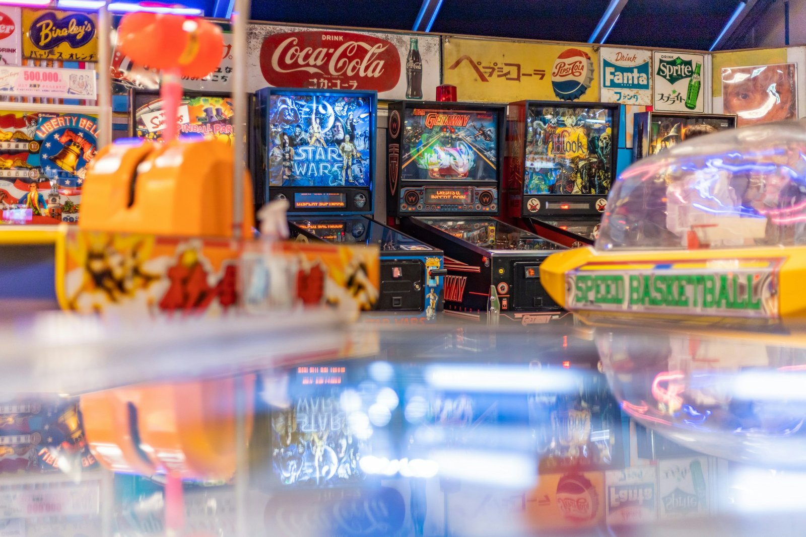Colorful retro arcade with pinball machines and classic cabinets