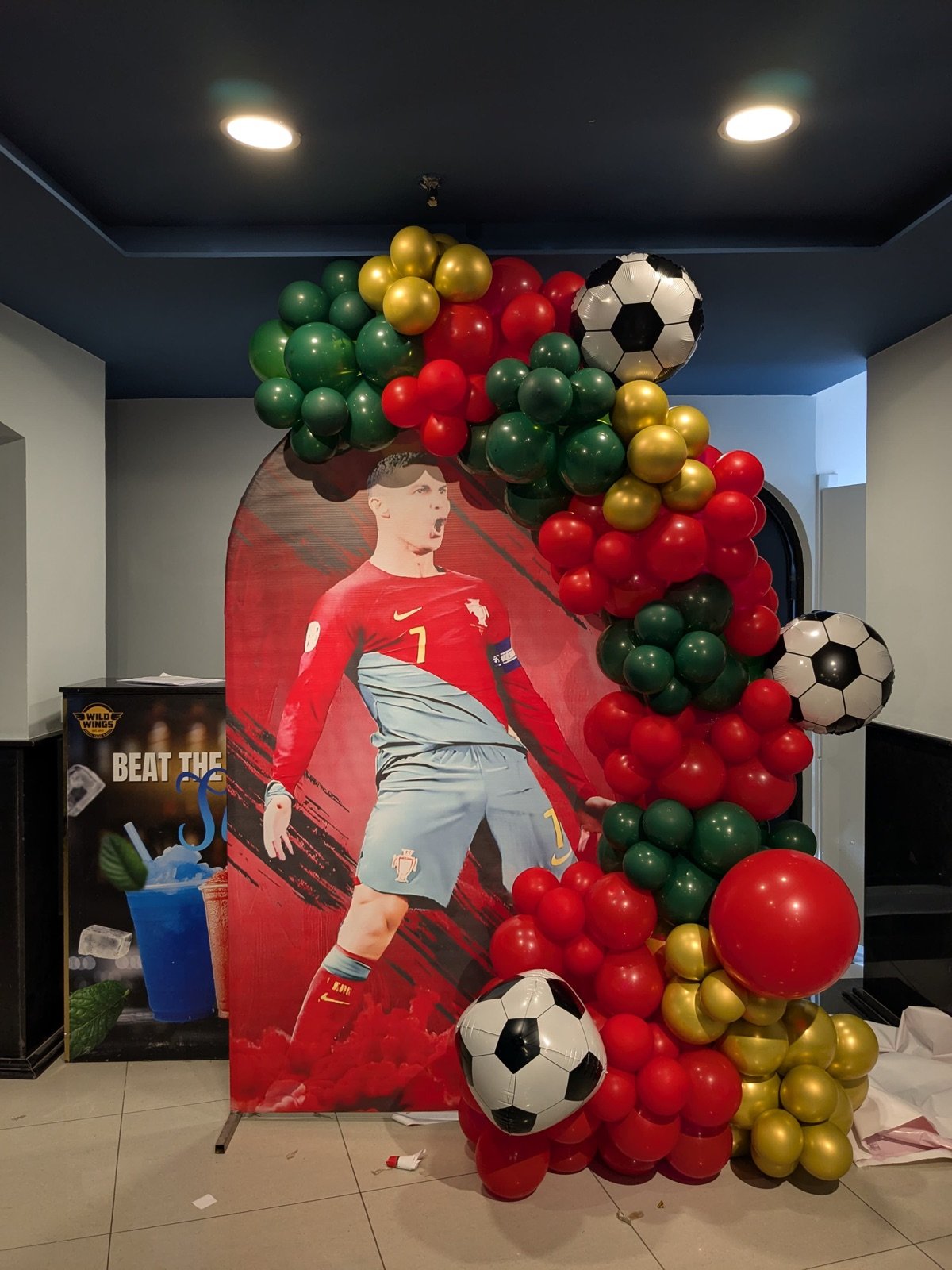 Football-themed birthday balloon arch with a Ronaldo cutout