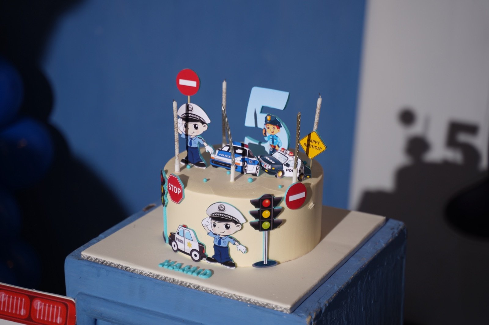 Police-themed birthday cake with traffic signs and candles