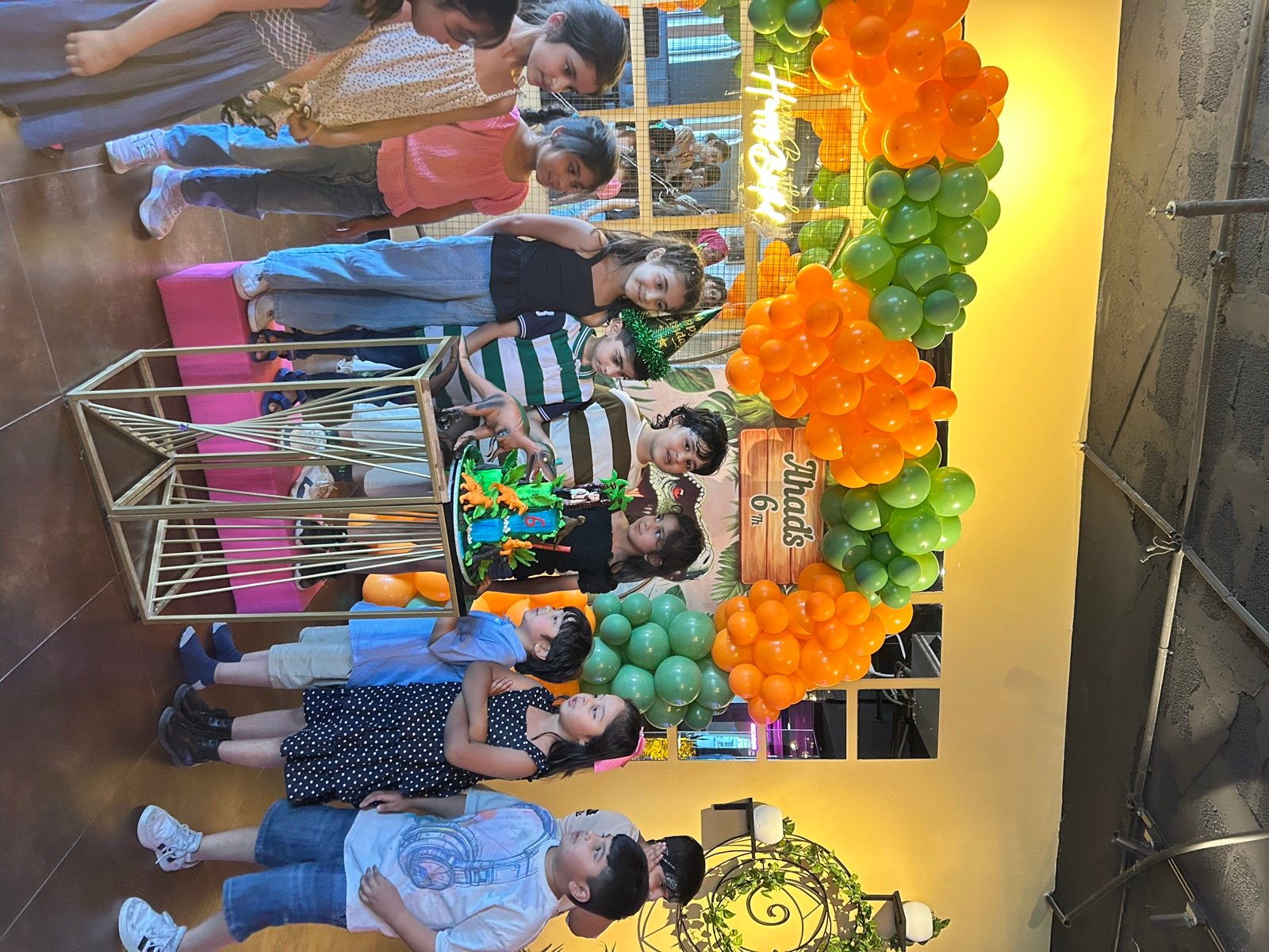 Dinosaur-themed 6th birthday — Ahad and friends around the cake