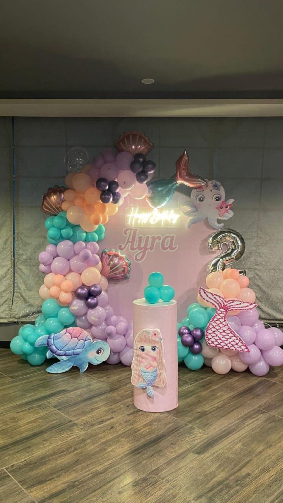 Mermaid-themed birthday setup for Ayra with pastel balloons